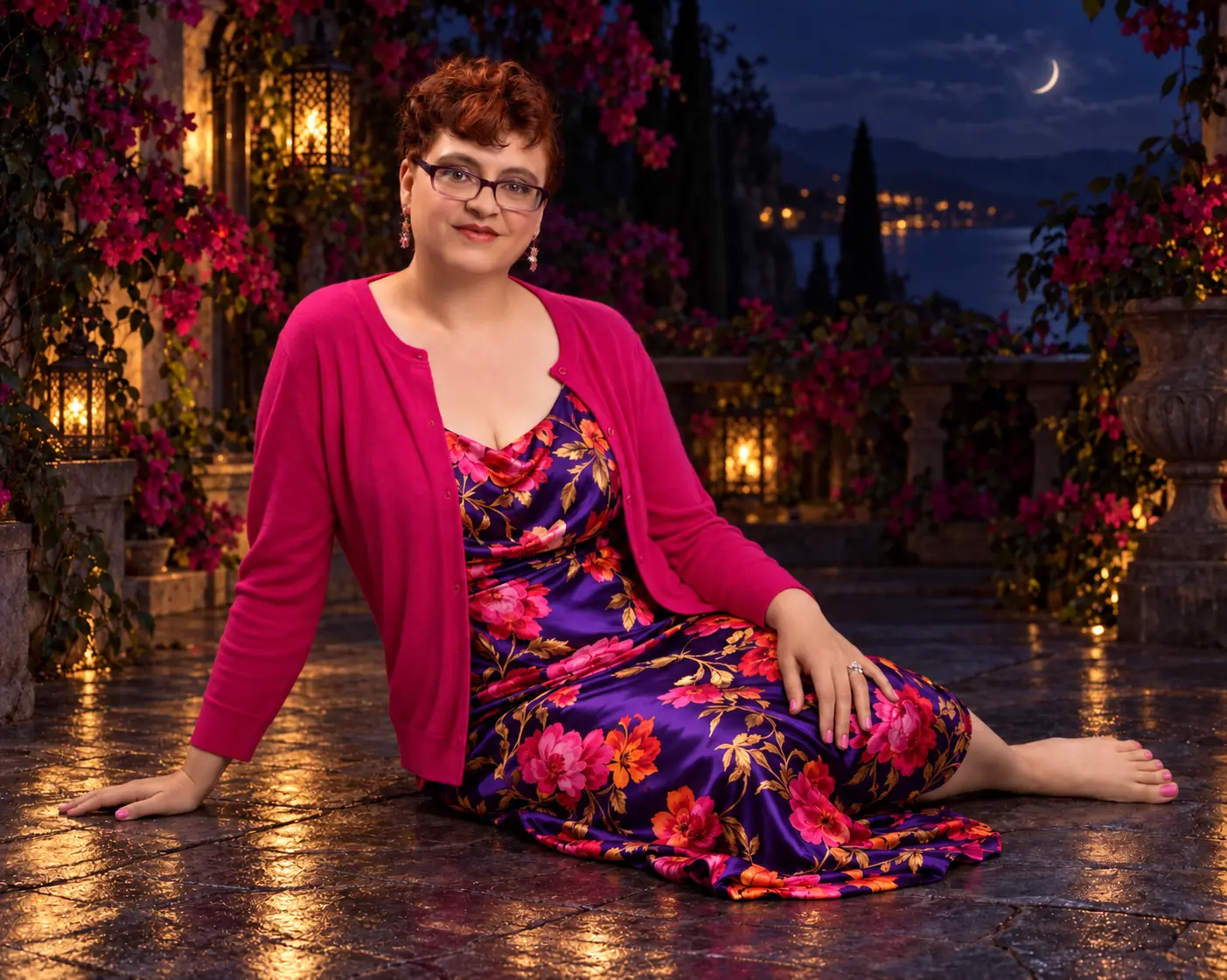 Nadia seated barefoot on a lantern-lit terrace in a purple floral dress and fuchsia cardigan